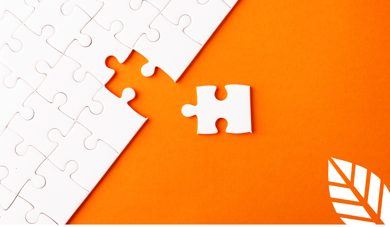 a white puzzle with one piece to the side on an orange background