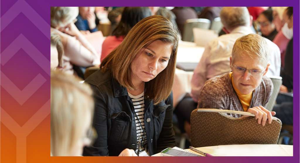 People looking at documents during an HLC in person event