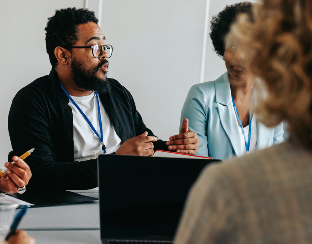 A roundtable discussion with several people at a table