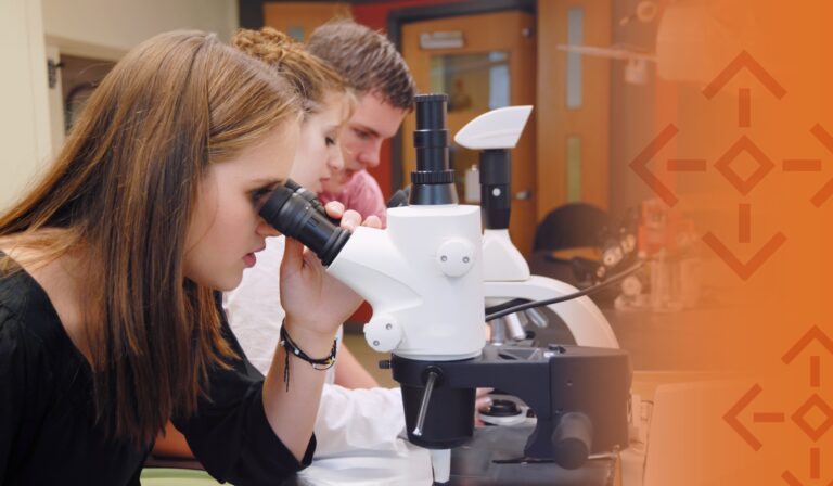 A student looking into a microscope